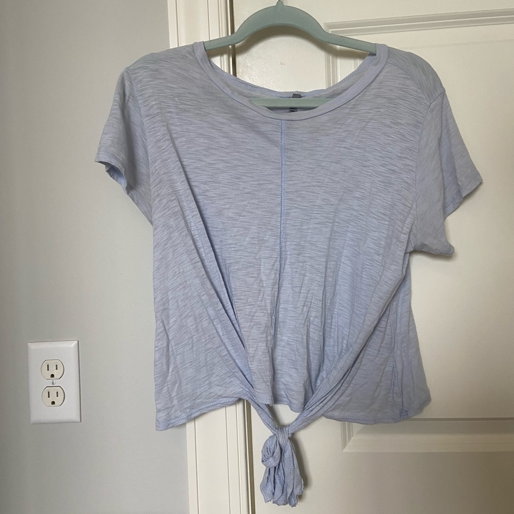 Jolie light blue shirt with tie at bottom